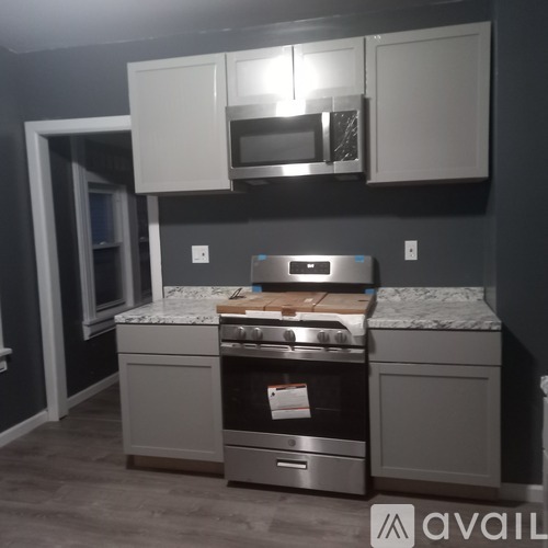 A kitchen with a stove top oven and microwave above it.