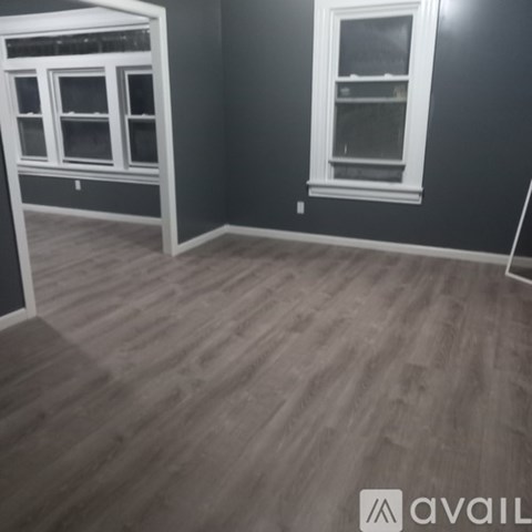 A room with a grey floor and a window.