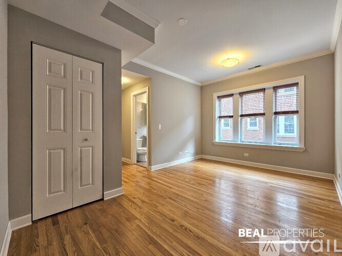 A room with wooden floors and a white door.