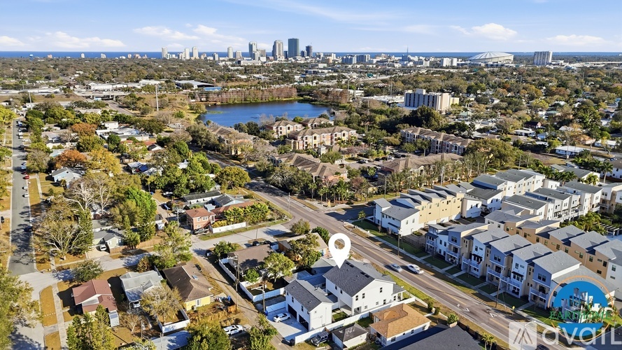 A cityscape with a lake and buildings in the background.