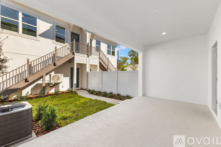 A modern house with a white exterior and a large open space.