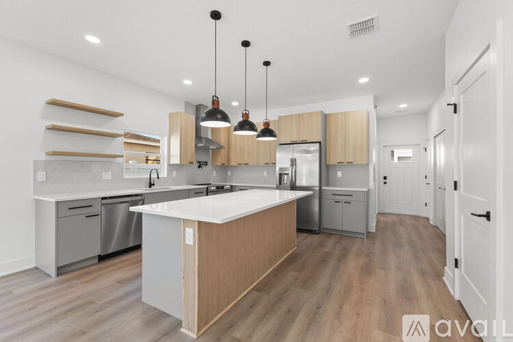 A modern kitchen with wooden cabinets and a central island.