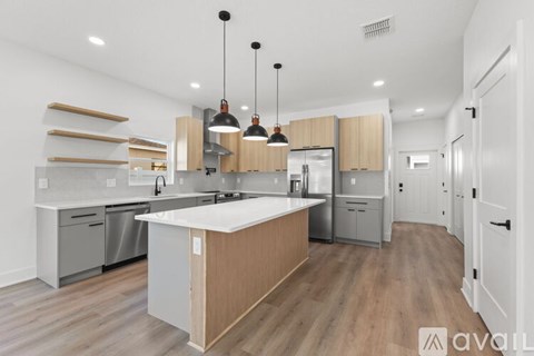 A modern kitchen with wooden cabinets and a central island.