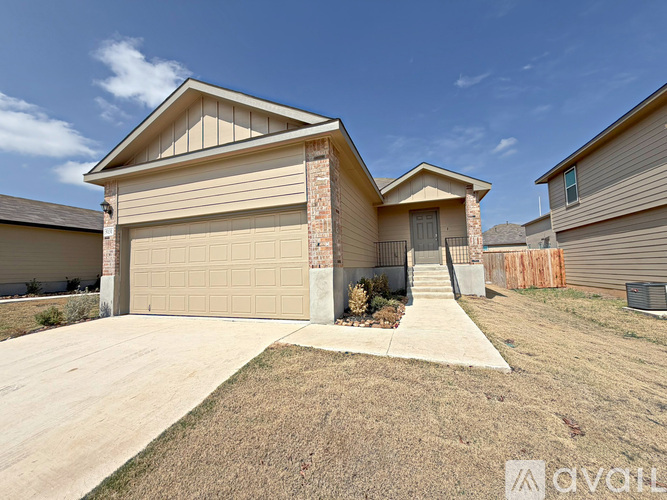 A two-story house with a garage is for sale.