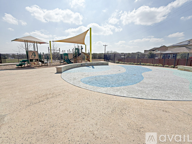 A large outdoor pool area with a yellow structure and a fence surrounding it.