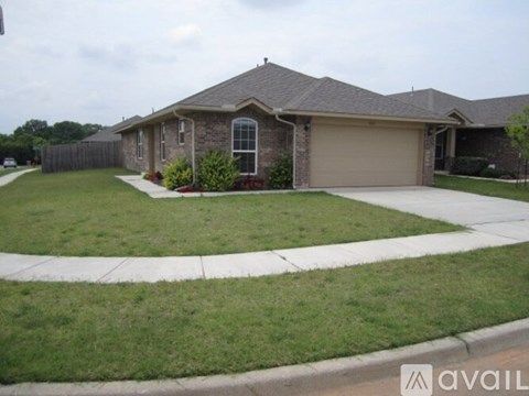 A house with a brown roof and a garage door.