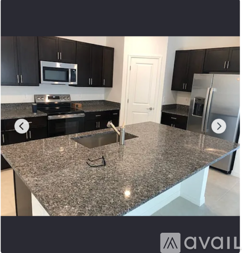 A kitchen with granite countertops and stainless steel appliances.