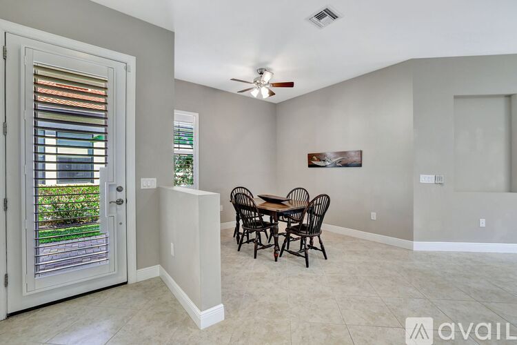 A dining room with a table set for four.