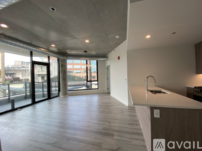 A modern kitchen with a large island and a view of the city.