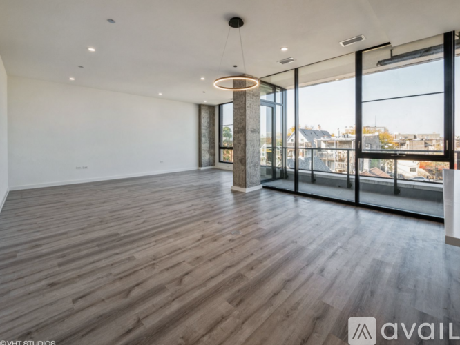 A modern kitchen with a large island and a view of the city.