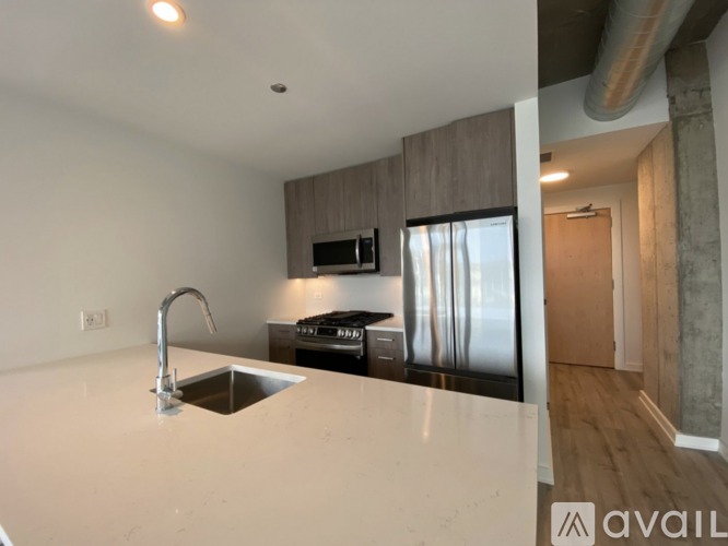 A kitchen with a sink and a microwave.