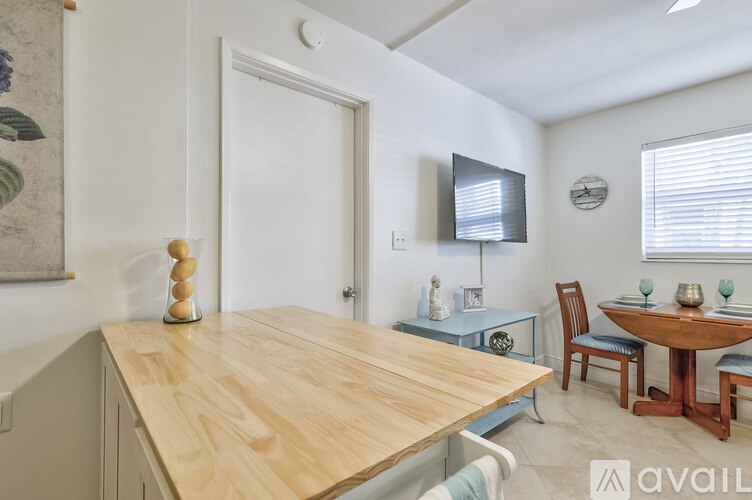 A dining area with a wooden table and chairs.