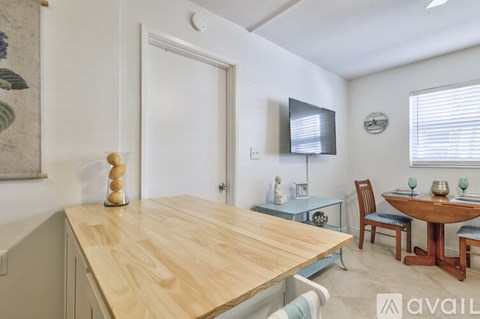 A dining area with a wooden table and chairs.