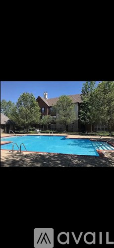 A large house with a pool in front.