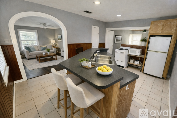 A kitchen with a table and chairs in the middle of the room.
