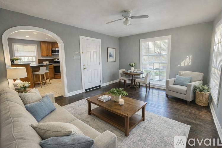 A living room with a grey couch and a wooden coffee table.