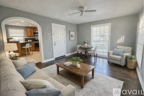A living room with a grey couch and a wooden coffee table.