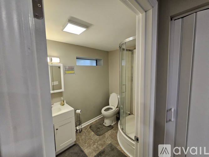 A bathroom with a toilet, sink, and shower.