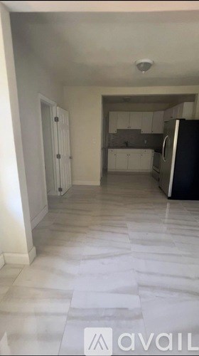 A kitchen area with a refrigerator and a countertop.