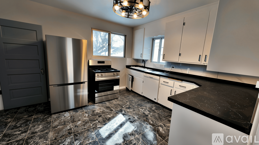 A kitchen with a black and white color scheme.
