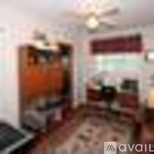 A living room with a couch and a television.