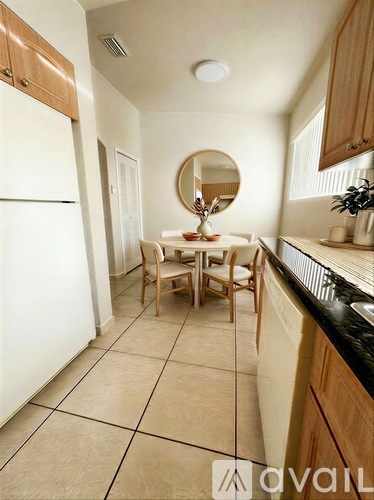 A kitchen with a table and chairs in the middle.