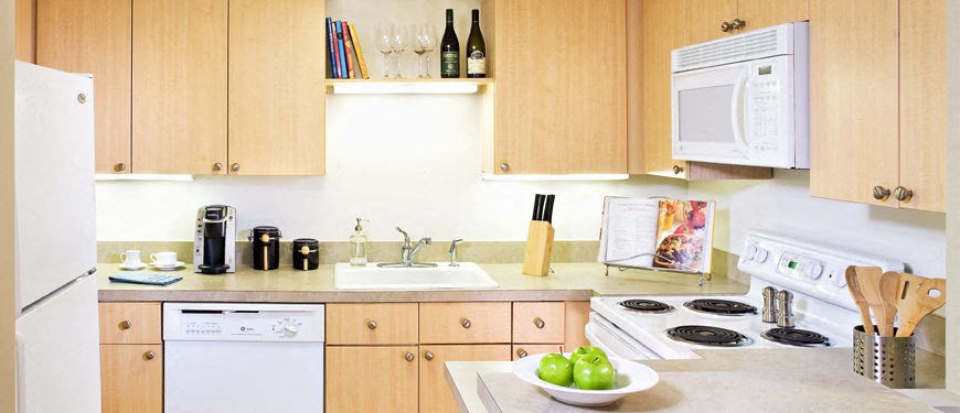 a kitchen with a sink a stove and a microwave