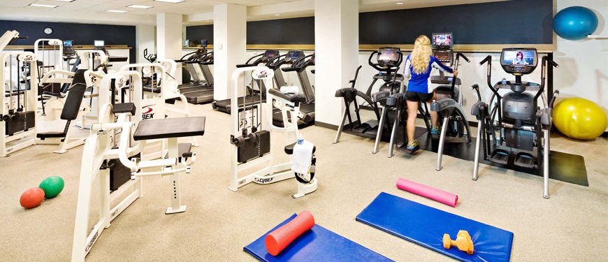 a woman working out in a gym with exercise equipment