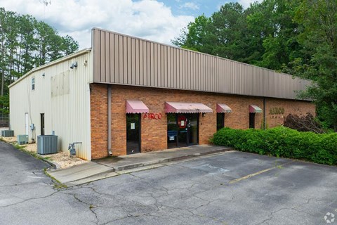 A building with a brown roof and a sign that says "FIRCO" on it.