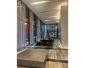 A modern office lobby with a Christmas tree in the background.