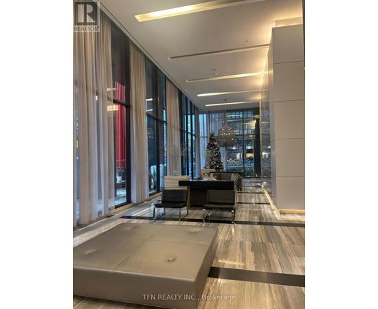 A modern office lobby with a Christmas tree in the background.