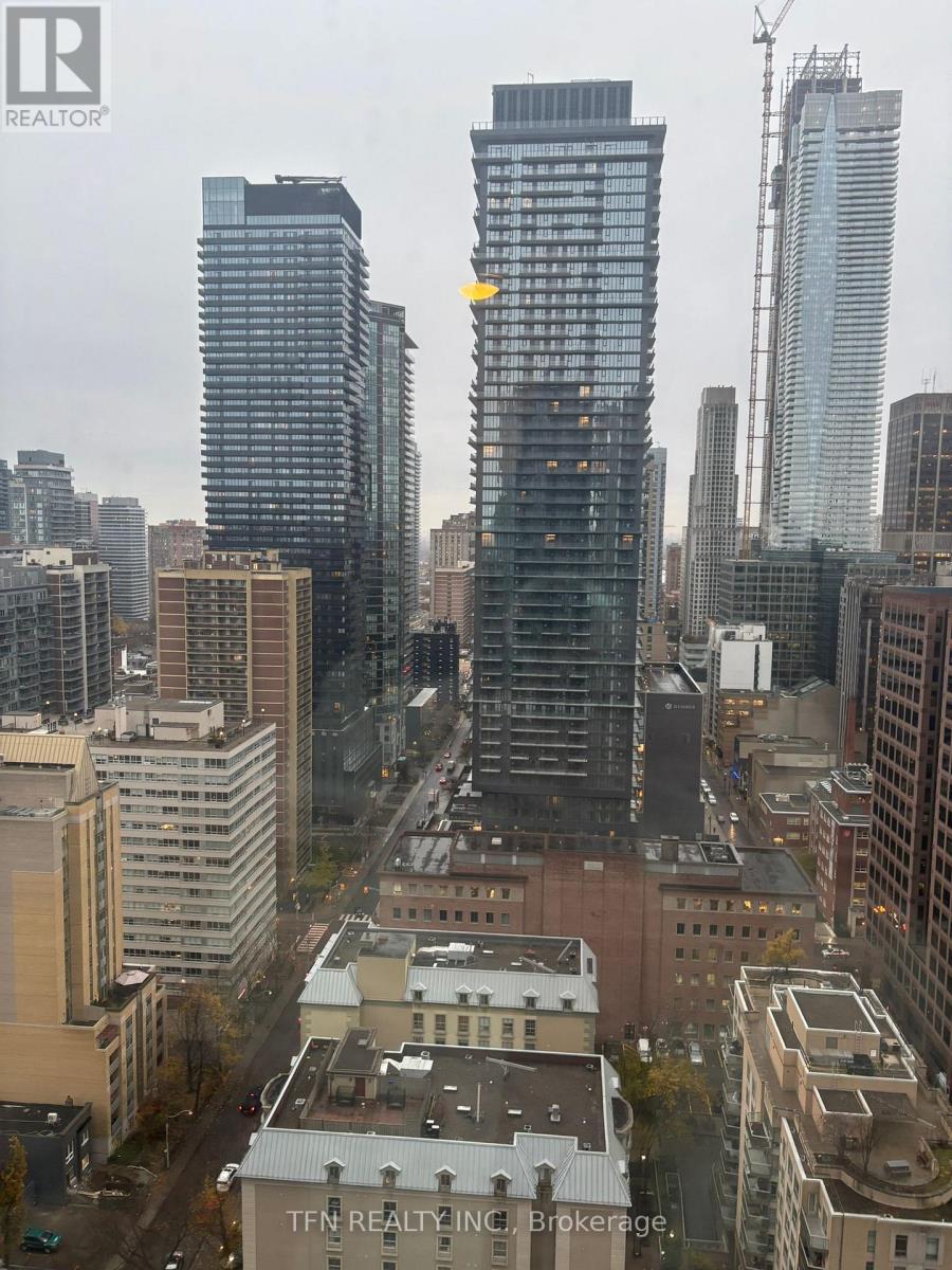 A cityscape with a building that has a yellow arrow on it.