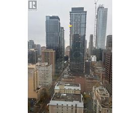 A cityscape with a building that has a yellow arrow on it.