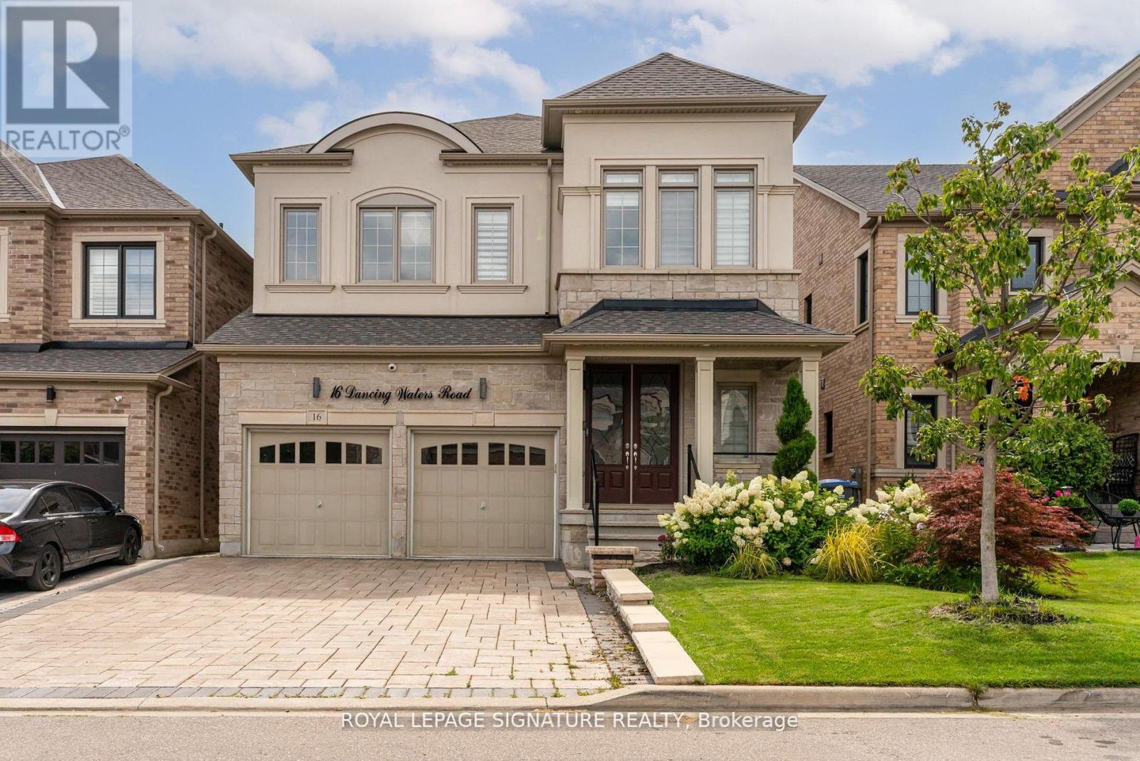 A large, two-story house with a garage is for sale.
