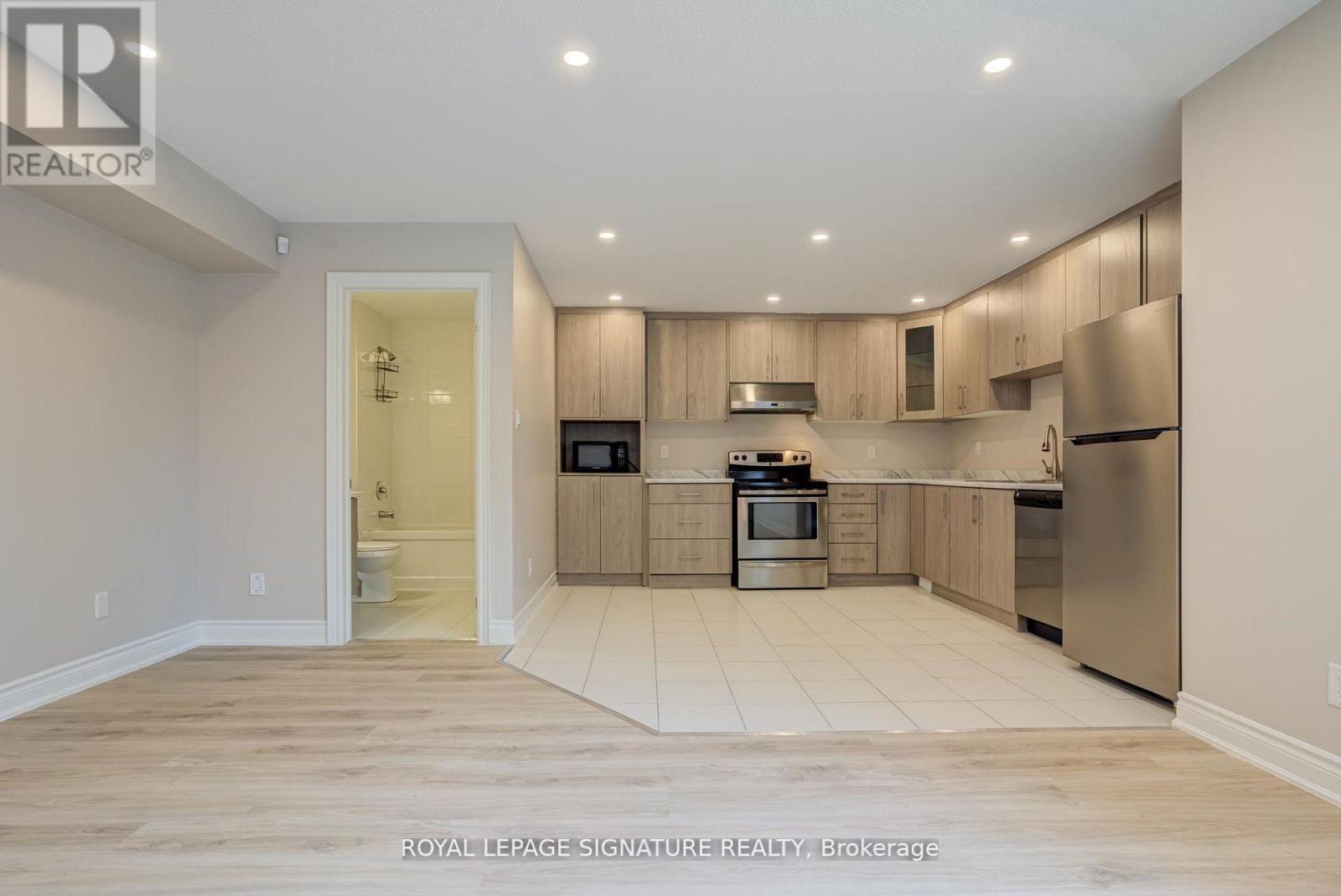 A kitchen with wooden cabinets and stainless steel appliances.