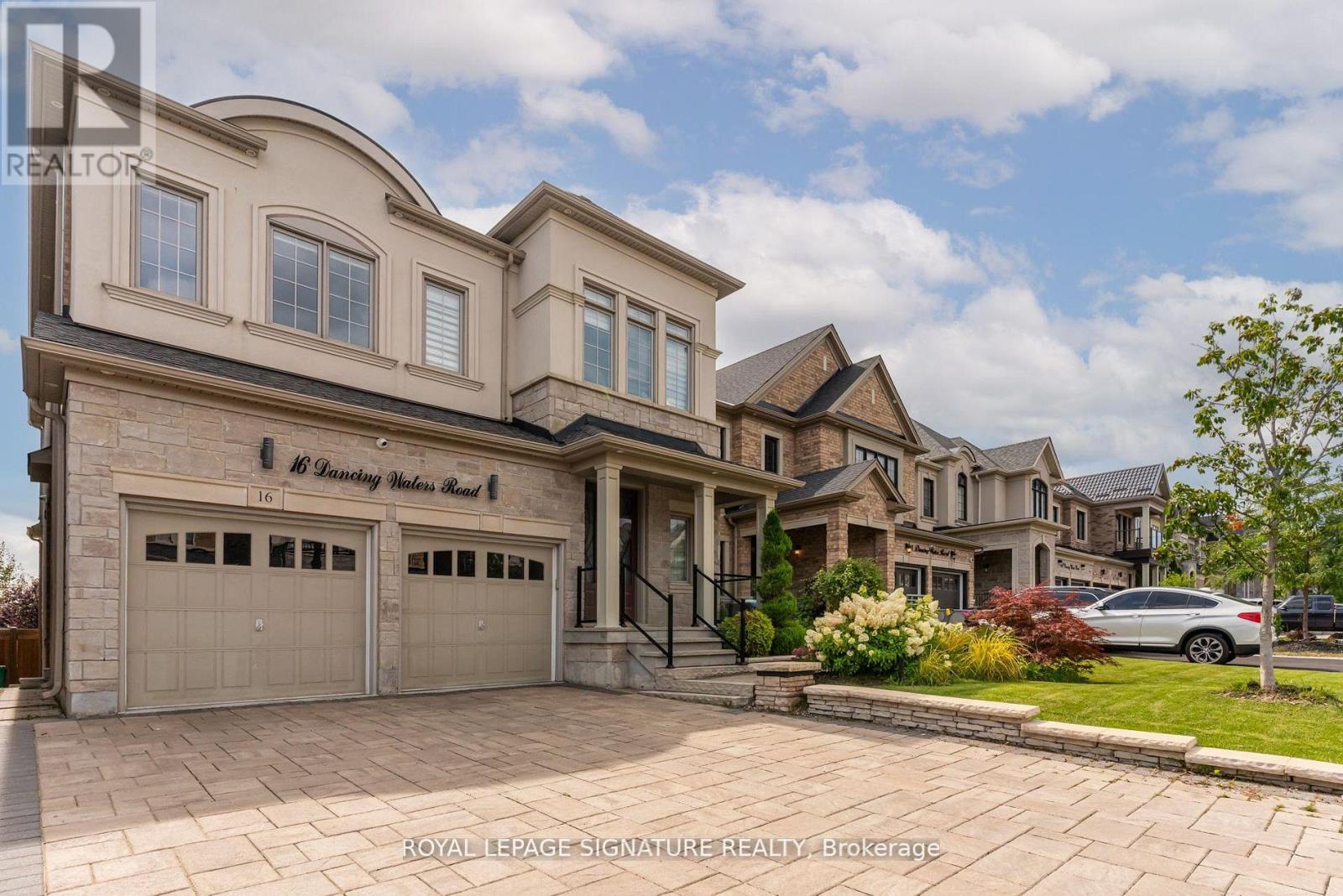 A large, two-story house with a garage is shown in the image.