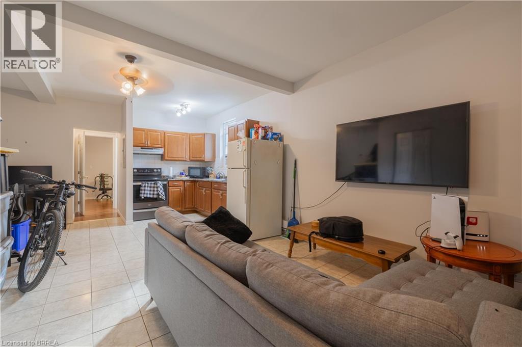A living room with a grey couch, a television, and a bicycle.