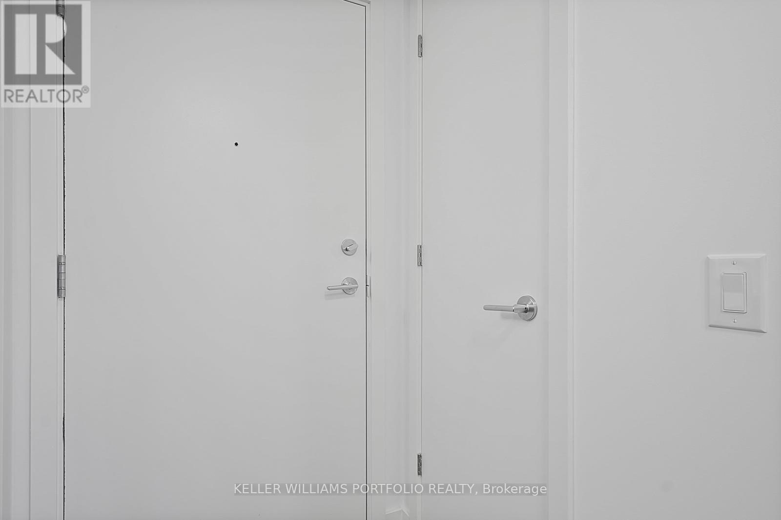 Two white doors with a Realty logo on the left.