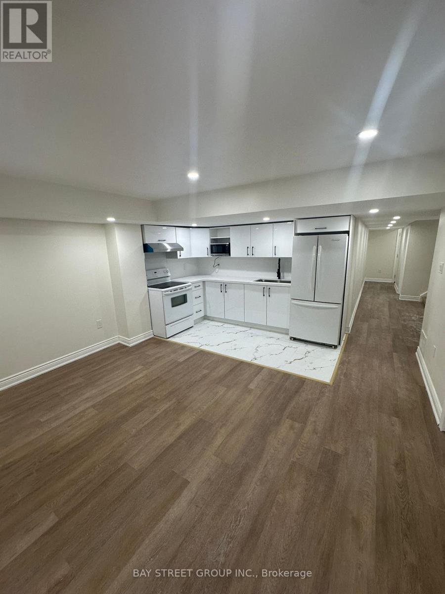 A large empty room with wooden floors and white walls.