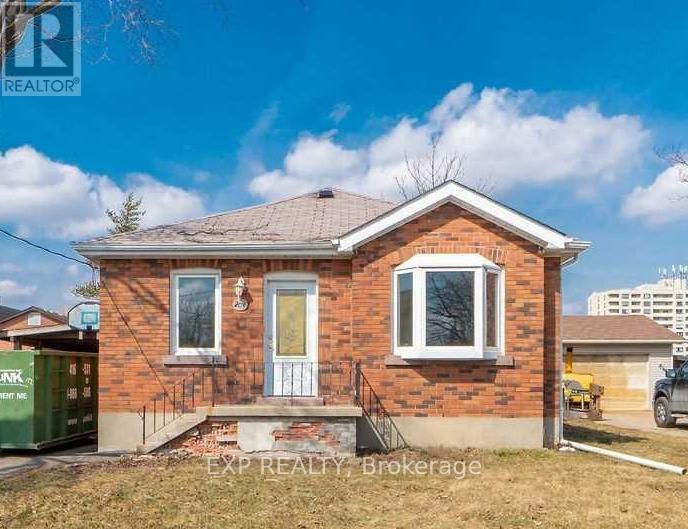 A small brick house with a white door and windows is for sale.