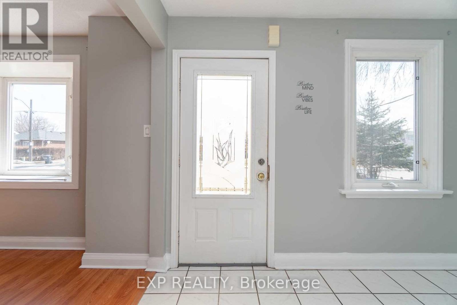 A white door with a gold handle is in the middle of a room.