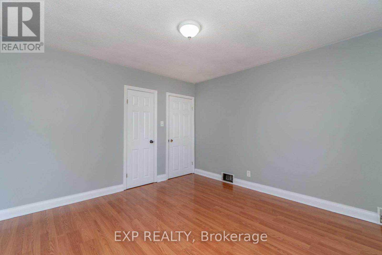 A room with EXP REALTY, Brokerage written on the floor.