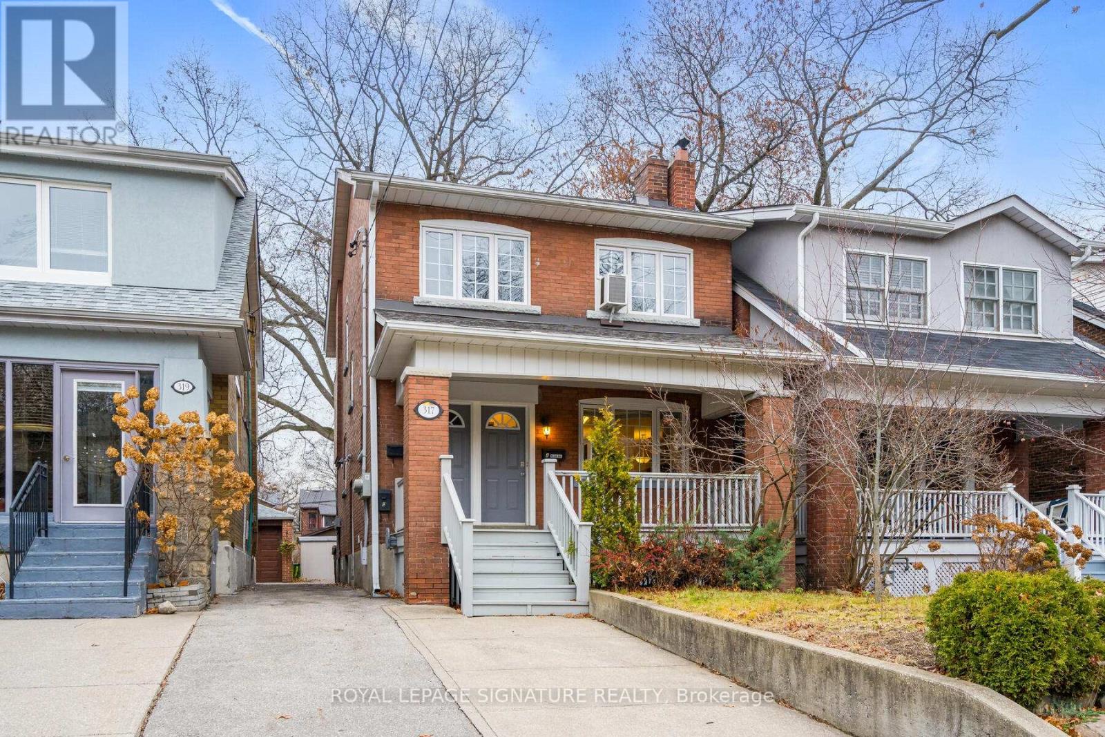 A house with a Royal LePage Signature Realty Brokerage logo on the front.