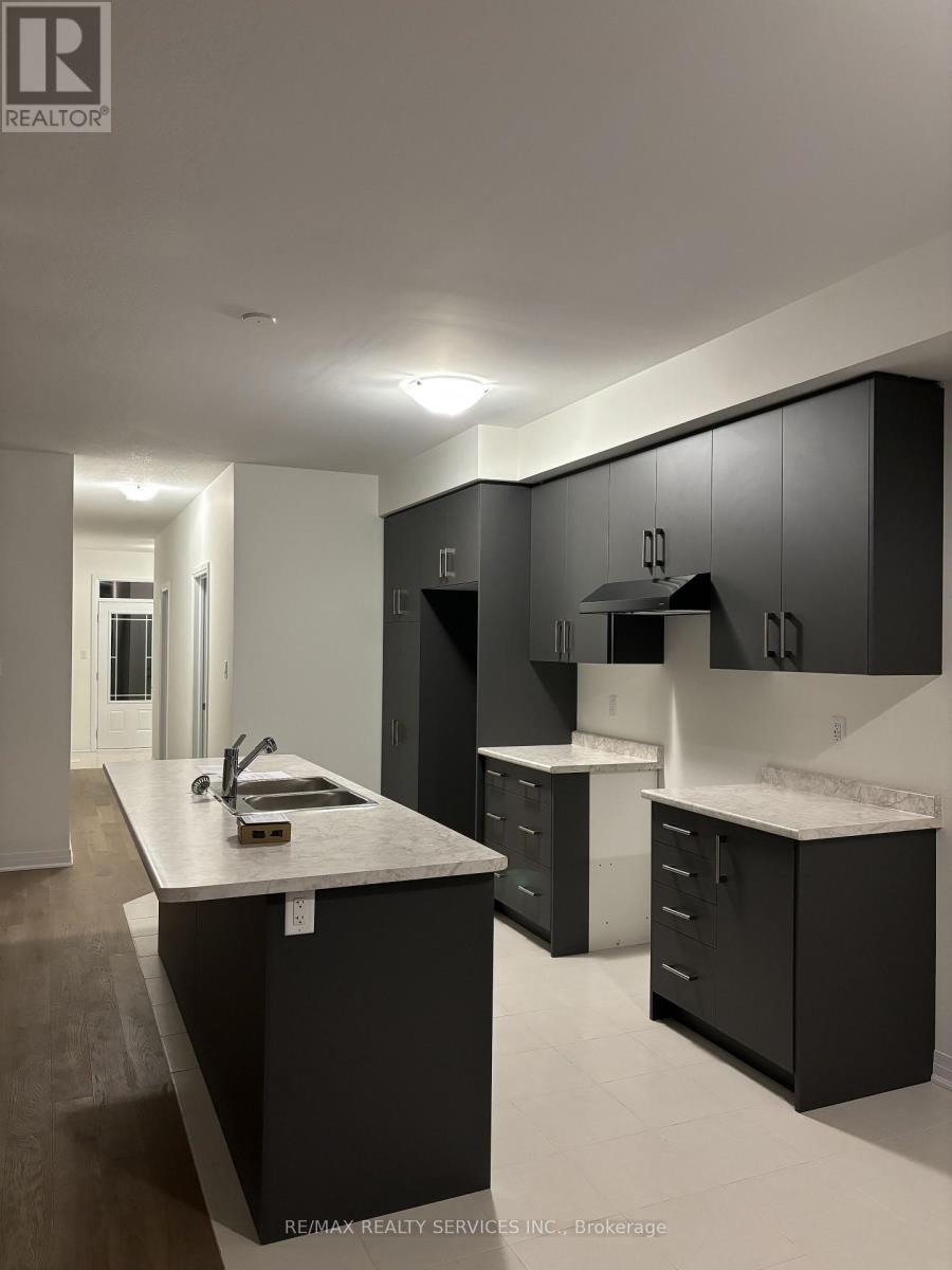 A modern kitchen with black cabinets and a white countertop.