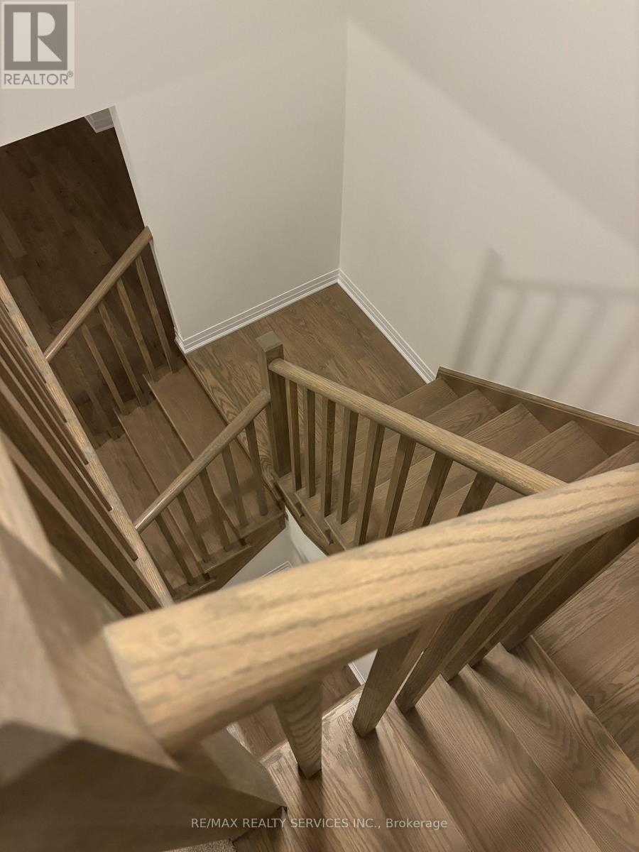A wooden staircase with a white wall in the background.