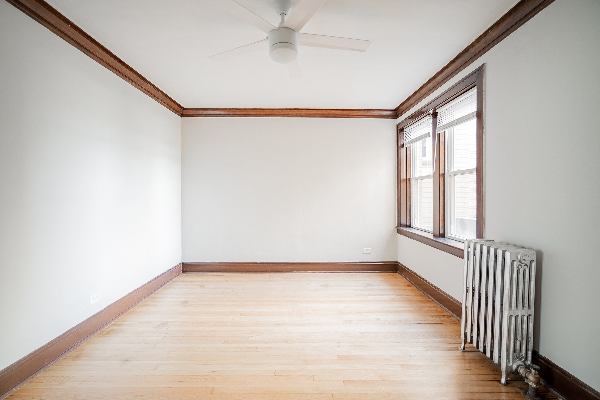 an empty room with a radiator and a window