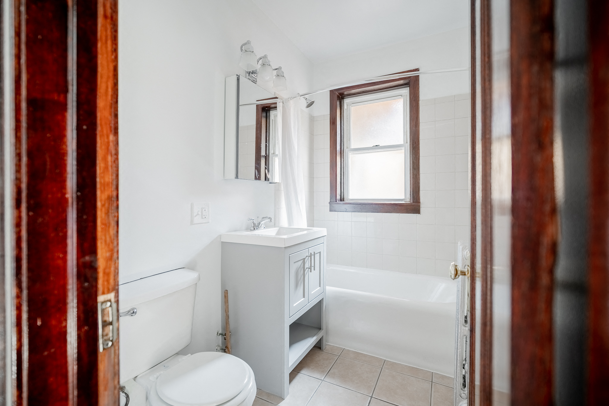 a bathroom with a toilet and a sink and a bath tub