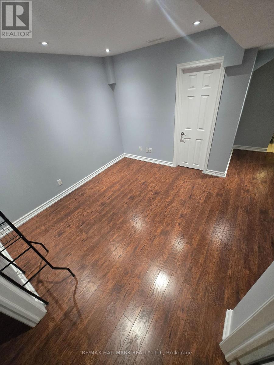 A room with a wooden floor and a white door.