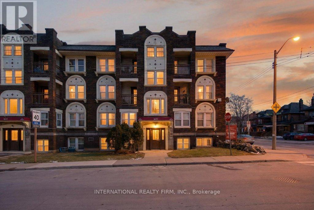 A building with the sign "INTERNATIONAL REALTY FIRM, INC., Brokerage" in front of it.