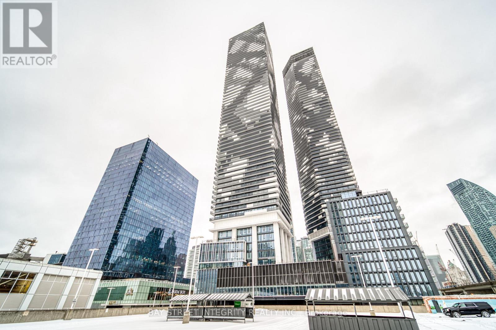 A cityscape with skyscrapers and a REALTOR® logo.
